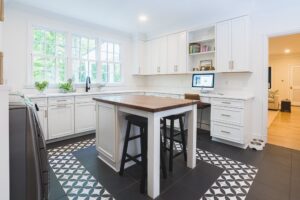 Bright modern laundry room with white cabinets and a wooden island