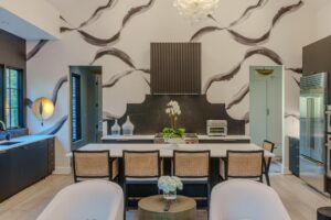Elegant modern kitchen with artistic wallpaper and sleek cabinetry
