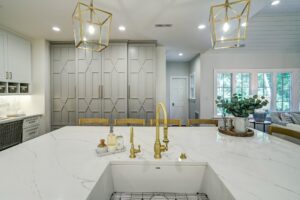 Elegant modern kitchen with gold fixtures and marble countertop
