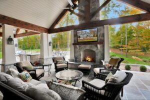 Wood burning fireplace in open covered porch with stone and wood beams