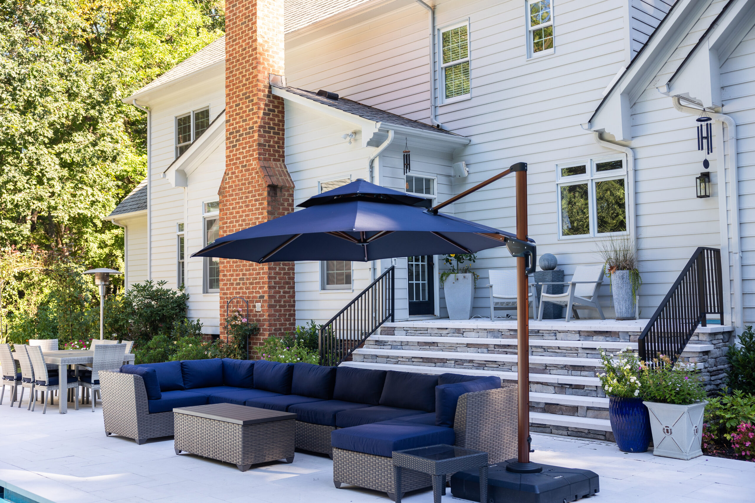 Travertine patio with bluestone stairs and patio furniture