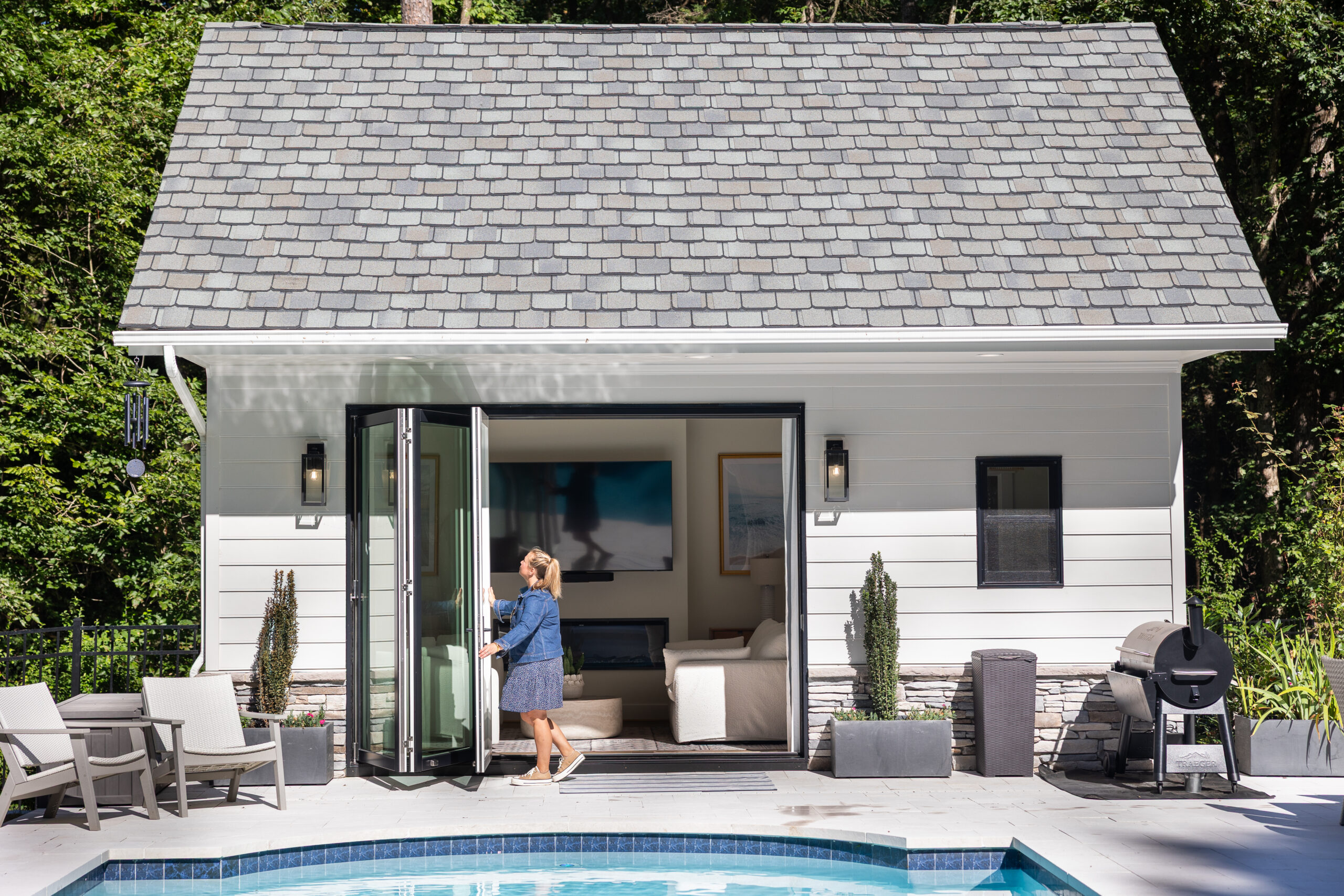 pool house with tri fold doors opened