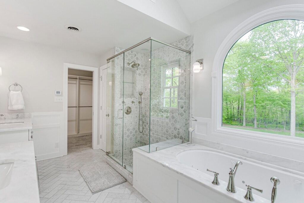 Beautiful marble and white bathroom with skirted tub